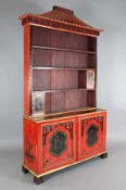 A Chinese Chippendale style red lacquered bookcase, with pagoda pediment, open shelves and