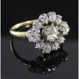 A Victorian gold, silver and diamond cluster ring, set with eleven old mine cut stones, size P.