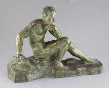 A. Ouline. An Art Deco bronzed terracotta figure of a seated man, on integral naturalistic base,