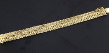 An early 1970's 18ct gold bracelet, with chevron style decoration, 7.25in.
