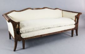 An 18th century style walnut settee, the show-wood frame carved in relief with flowers and foliate