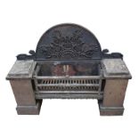 A Regency steel and cast iron fire grate, the arched back with applied Anthemion and scroll