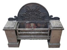 A Regency steel and cast iron fire grate, the arched back with applied Anthemion and scroll