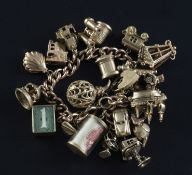 A 9ct gold charm bracelet, hung with twenty two assorted 9ct gold charms including binoculars,
