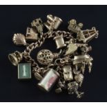 A 9ct gold charm bracelet, hung with twenty two assorted 9ct gold charms including binoculars,