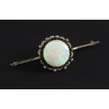 A Edwardian white gold, white opal and diamond set bar brooch, the central opal measuring 18mm in