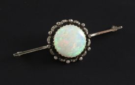 A Edwardian white gold, white opal and diamond set bar brooch, the central opal measuring 18mm in