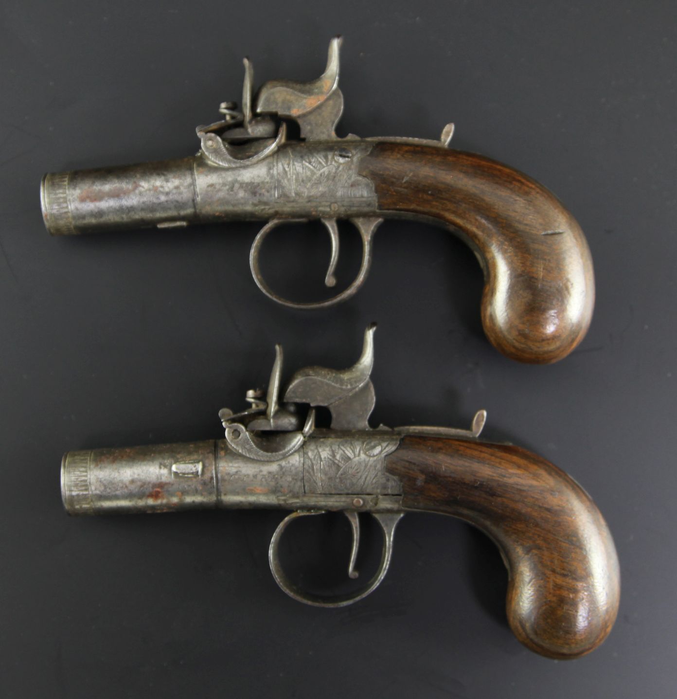 A pair of early 19th century boxlock percussion cap pistols, with cylindrical barrels, converted