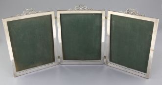 A George V silver mounted triptych photograph frame, with ribbon bow surmounts and engraved