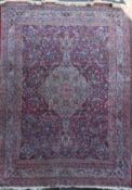 A Kashan red ground carpet, with central foliate medallion in a field of scrolling foliage, with