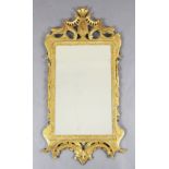 A George II carved and giltwood wall mirror, possibly Irish, carved with scrolls and foliate
