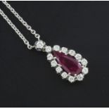 An 18ct white gold, ruby and diamond set drop pendant necklace, the teardrop shaped ruby weighing