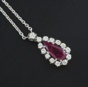 An 18ct white gold, ruby and diamond set drop pendant necklace, the teardrop shaped ruby weighing