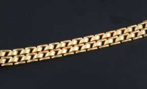 A stylish mid 20th century 14ct gold bracelet, with raised panelled links, 7.75in.