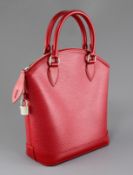 A Louis Vuitton red leather handbag, with original padlock and one key, in slip case, 12in.