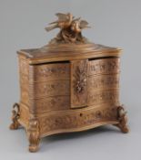 A late 19th century Black Forest carved wood jewellery casket, surmounted by two birds and carved