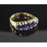 An 18ct gold and graduated five stone sapphire half hoop ring, the setting set with twelve diamond