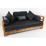 A Continental Art Deco walnut settee, with show-wood frame and black fabric upholstery, W.6ft