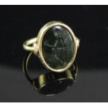 A Roman green chalcedony intaglio in a later gold ring mount, carved with the figure of a gentleman,