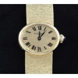A lady's 1970's 18ct gold Baume & Mercier manual wind wrist watch, with oval Roman dial, on textured