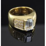 A modern 18ct gold and single stone aquamarine dress ring, with diamond set shoulders, size I.