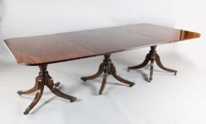 A Regency mahogany extending dining table, with reeded rounded rectangular top, three urn shaped