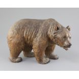 A Black Forest carved wood model of a bear, c.1900, with glass inset eyes, 12in. height 8.5in.