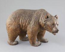 A Black Forest carved wood model of a bear, c.1900, with glass inset eyes, 12in. height 8.5in.
