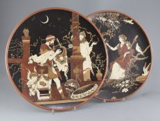 Heinrich Schlitt for Mettlach - two stoneware chargers, c.1900, the first decorated with a Greek