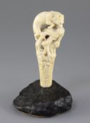 A 19th century French ivory cane handle, carved with a fox and hare, on a naturalistic stone base,