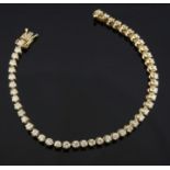 A modern 14ct gold and diamond line bracelet, set with forty six round brilliant cut stones, 7in.