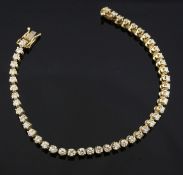 A modern 14ct gold and diamond line bracelet, set with forty six round brilliant cut stones, 7in.