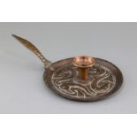John Pearson. A Newlyn copper chamberstick, c.1899, the well of the dish base embossed and chaste