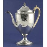 A George III silver urn shaped pedestal coffee pot, with ivory handle and plain body, on oval