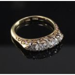 An early 20th century 18ct gold and graduated five stone diamond ring, set with old round cut