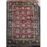 A large Agra red ground carpet, with gold floral decoration and three row floral borders and guards,