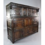 A late 17th century oak court cupboard, with carved frieze dated 1680, and two side doors over an