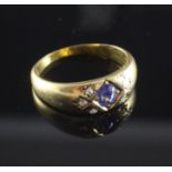 A late Victorian 18ct gold, gypsy set sapphire and diamond ring, with oval cut sapphire and rose cut