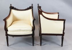 A pair of Louis XVI style carved rosewood armchairs, with ribbon and flower carved show-wood frames,