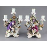 A pair Meissen figural three branch candelabra, late 19th century, each modelled with rococo scrolls