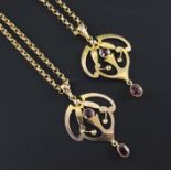 A pair of Edwardian Art Nouveau 9ct gold and garnet set drop pendants on 9ct gold chains, pendants