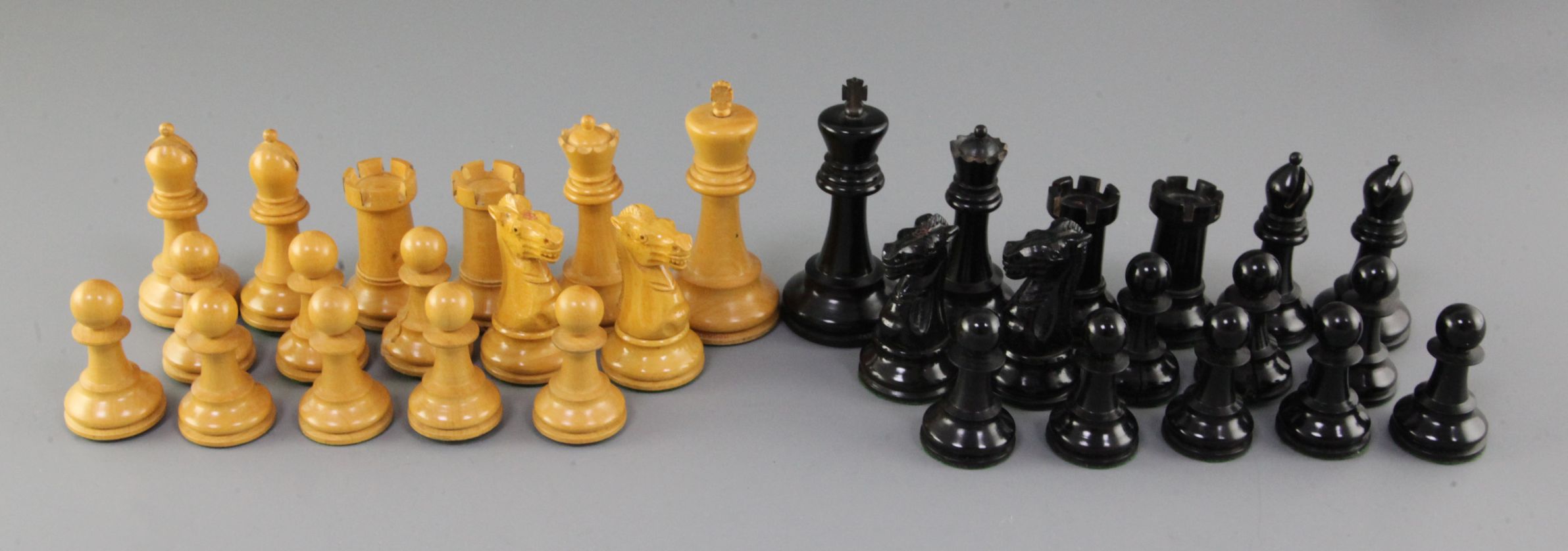 A Jaques & Son Staunton pattern ebony and boxwood library chess set, in original wooden case, with