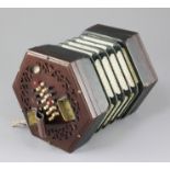 A Victorian rosewood concertina, with 24 buttons to each side and trade label for H. Farrant,