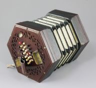 A Victorian rosewood concertina, with 24 buttons to each side and trade label for H. Farrant,