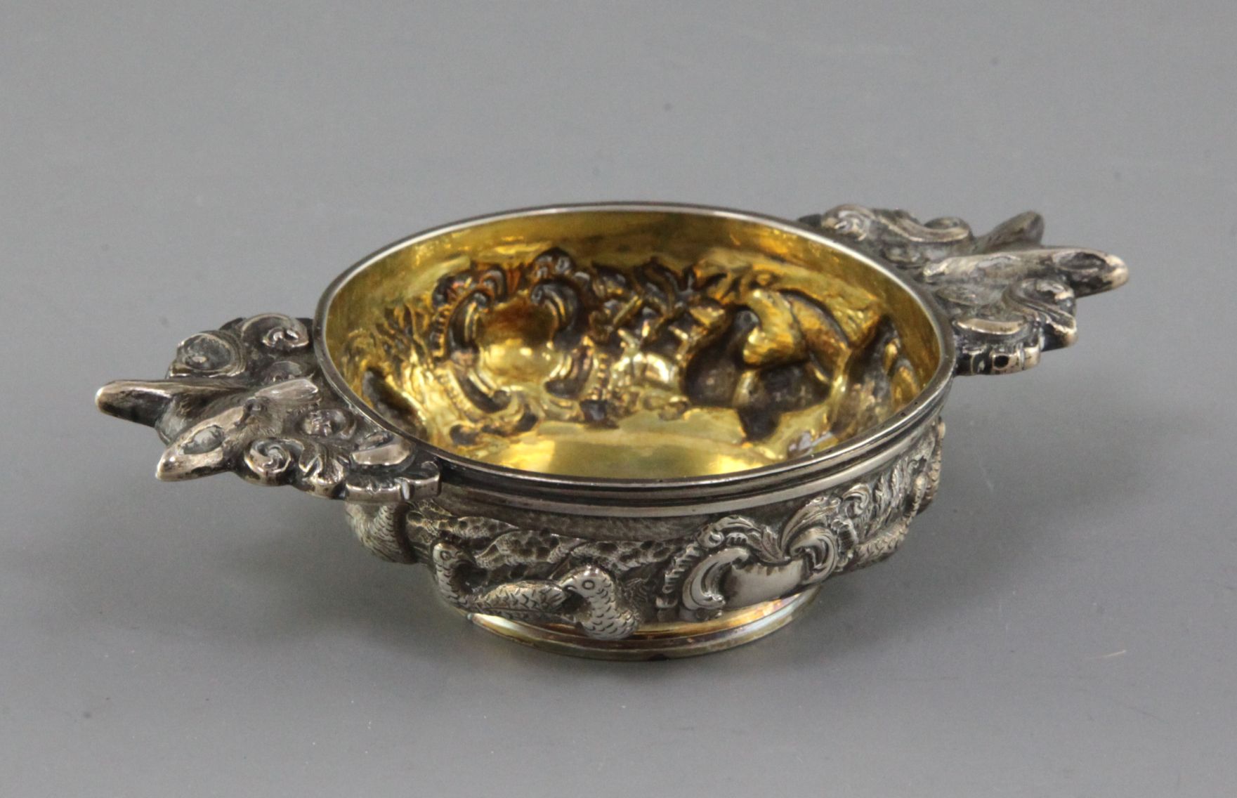 A George IV Scottish embossed silver quaich, decorated with continuous scene of game birds and fox