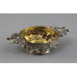 A George IV Scottish embossed silver quaich, decorated with continuous scene of game birds and fox