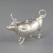 A 1960's German sterling silver cow creamer, the hinged cover embossed with a fly, import marks