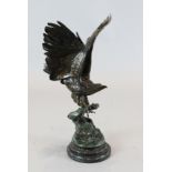 After Jules Moigniez (1835-1894). A bronze model of an eagle, perched upon a rocky outcrop, signed