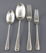 An Edwardian part canteen of silver Hanovarian rat tail flatware by Elkington & Co, comprising