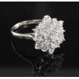 An 18ct white gold and diamond star shaped cluster ring, size M.